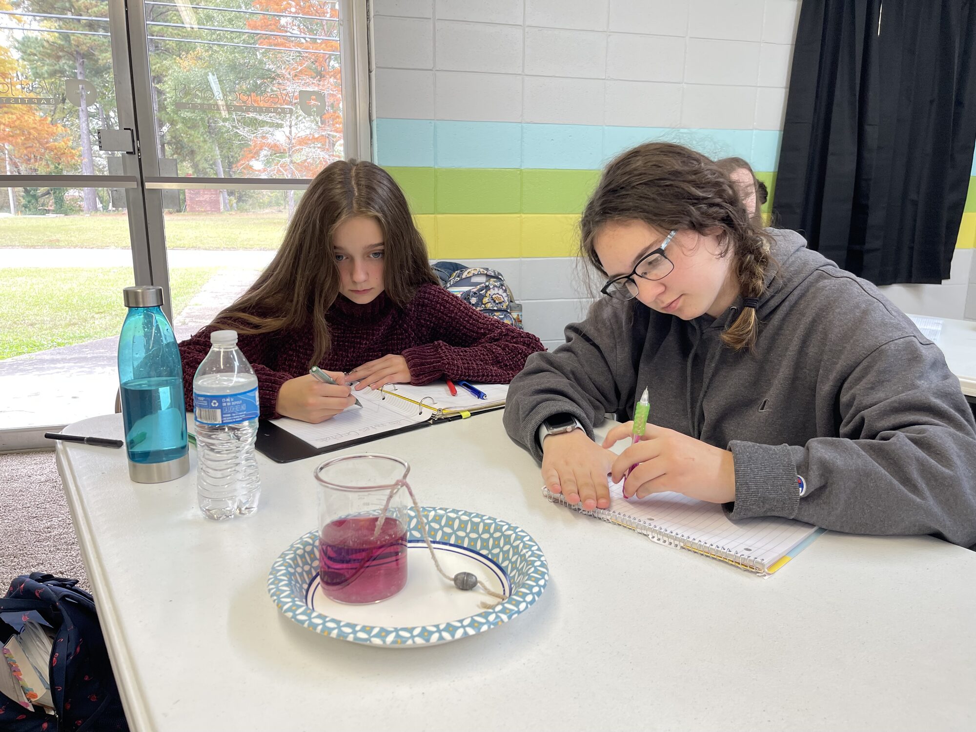Students taking notes during a science experiment
