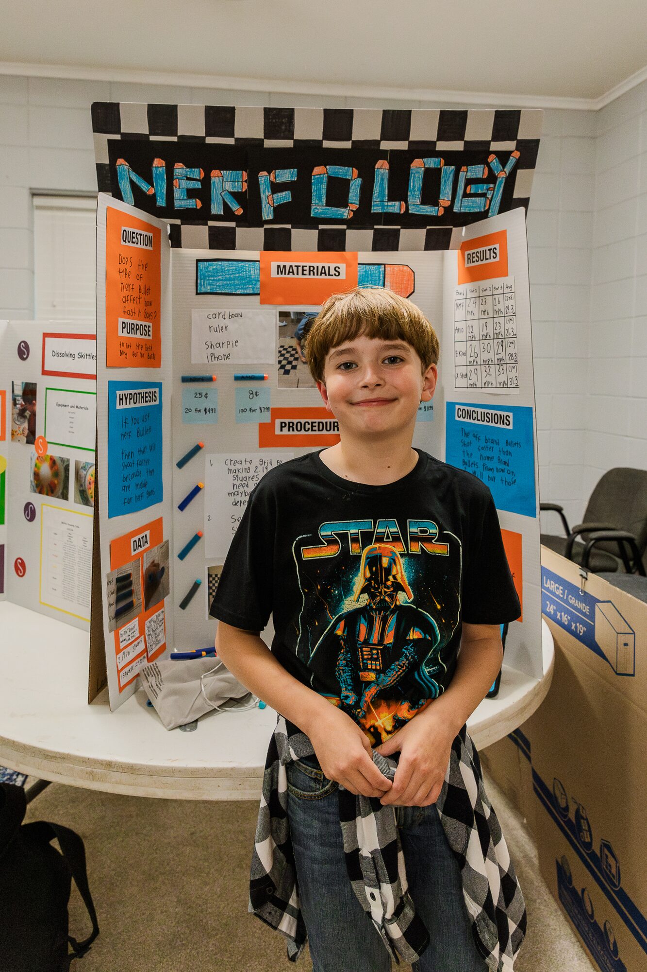 A student with his science fair project board